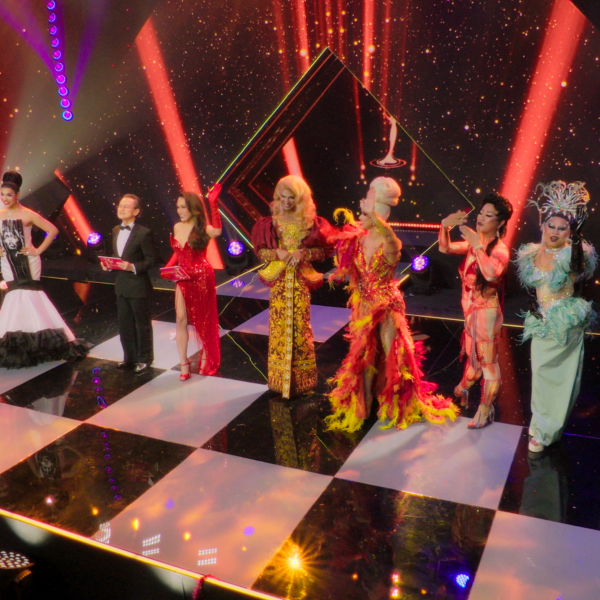 Cast and guest judges of Drag Race Philippines: Slaysian Royale standing on the main stage in glamorous outfits during the premiere episode.